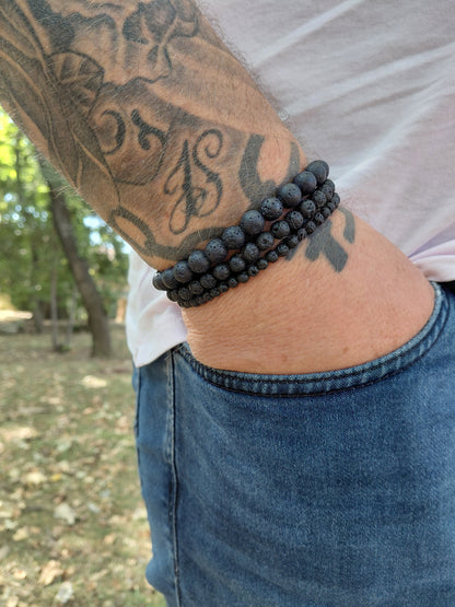 Bracelet pierre de lave naturelle, porté poignet homme en lumière extérieure — Zoéline